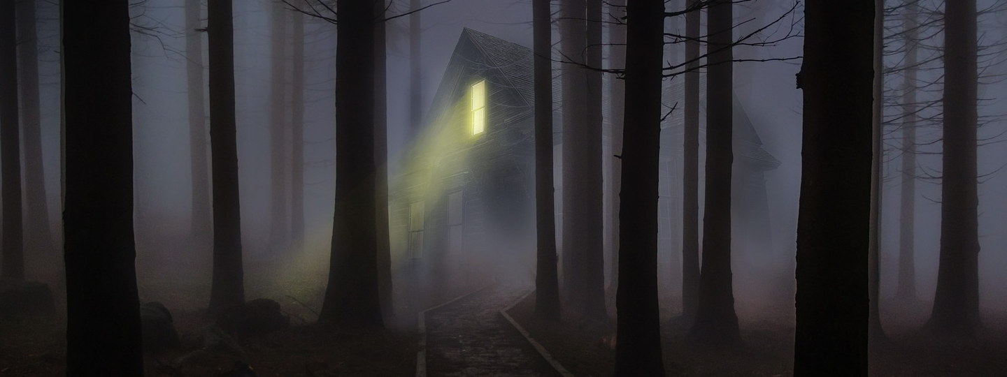 A spooky scene of a cabin in dense fog and trees at night