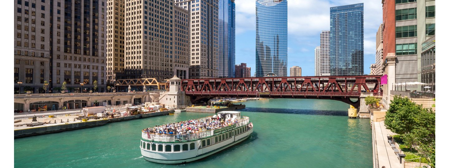 A crowded tourist boat floating through downtown Chicago, Illinois