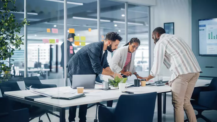 Diverse Team of Professional Businesspeople Meeting in the Office Conference Room. Creative Team Around Table, Black Businesswoman, African-American Digital Entrepreneur and Hispanic CEO Talking.